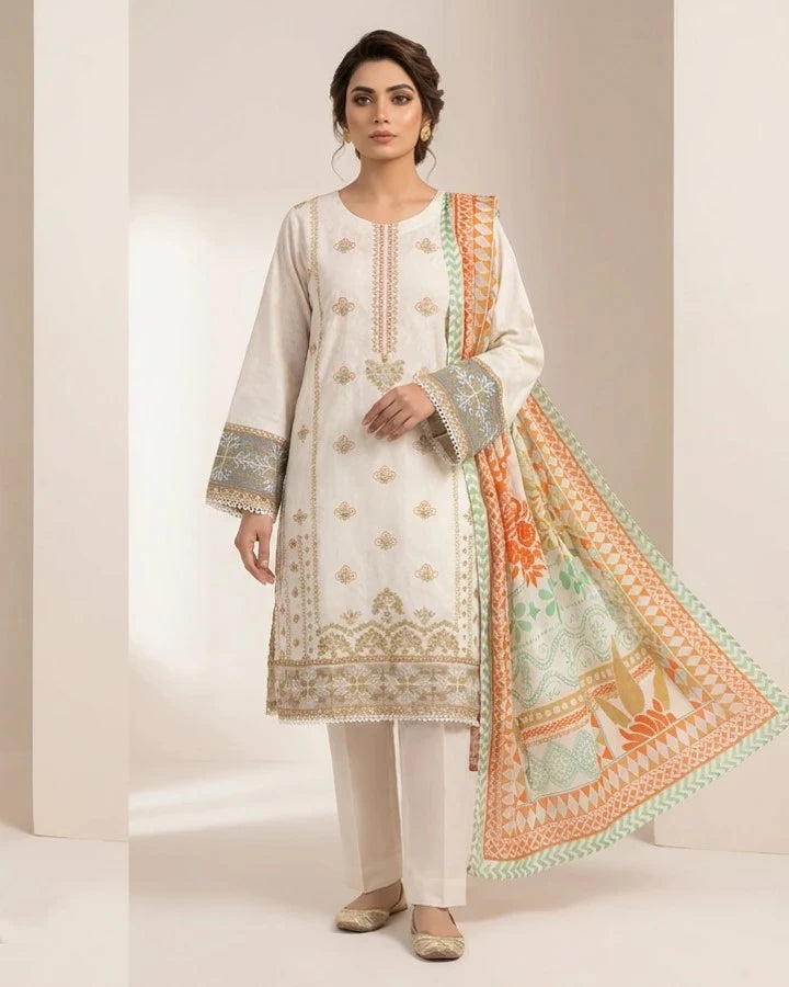 A woman models a traditional South Asian three-piece salwar kameez suit. The set features an off-white long kurta with gold and silver embroidery, matching off-white trousers, and a coordinating printed dupatta in orange, green, and white.